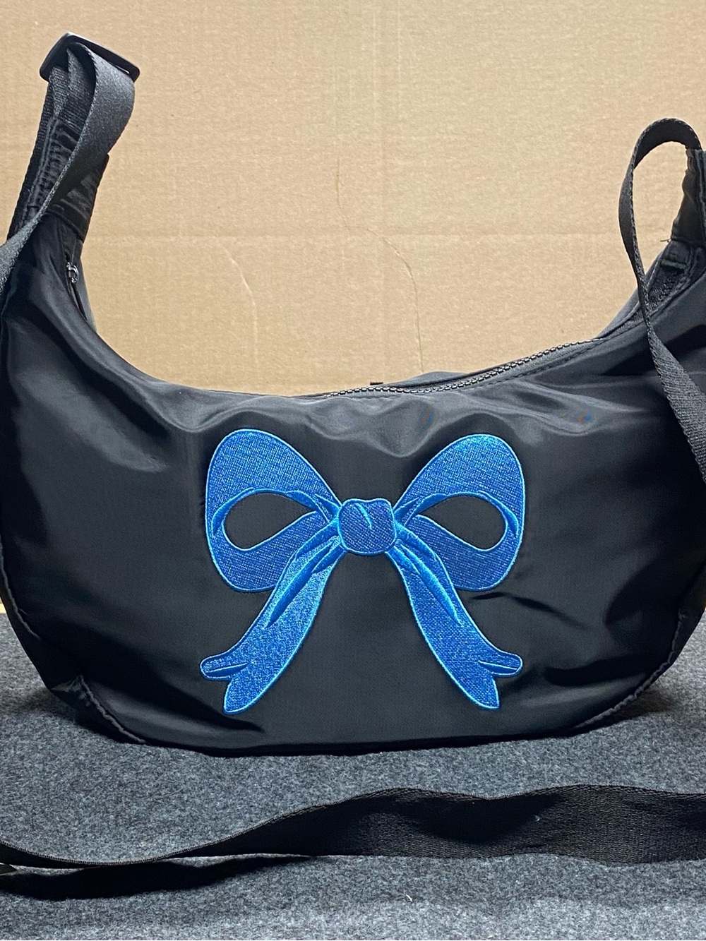 Black Shoulder Bag with Blue Bow Accent by